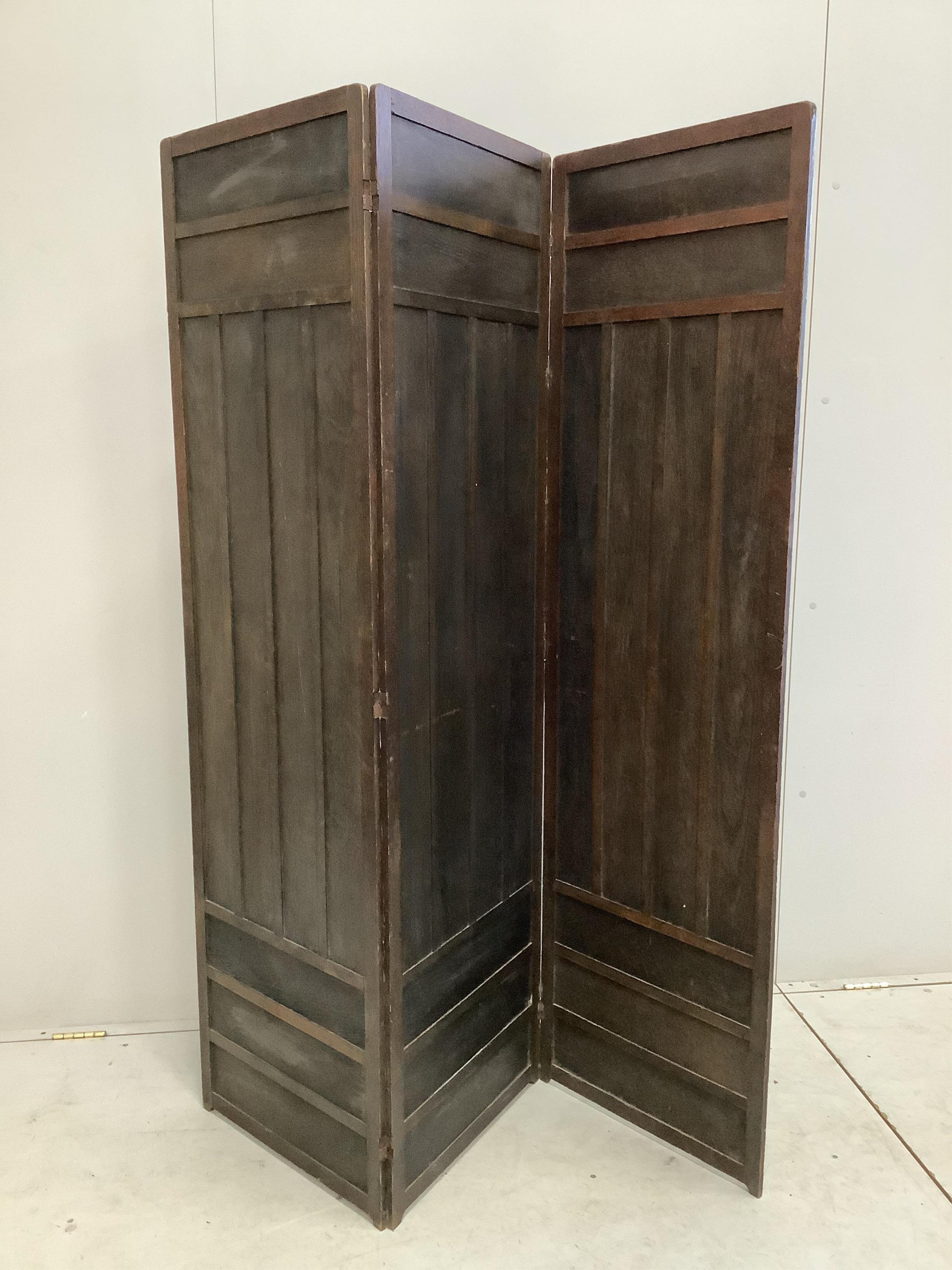 A Liberty & Co. Arts & Crafts pokerwork oak three fold dressing screen, each panel width 50cm, height 174cm. Condition - fair